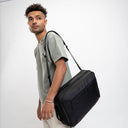 Slim laptop briefcase with structured design and hidden backpack straps—smart look with gear protection.